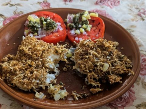 Baked Sea Bream with potatoes in crispy parmesan crust with tomato salad