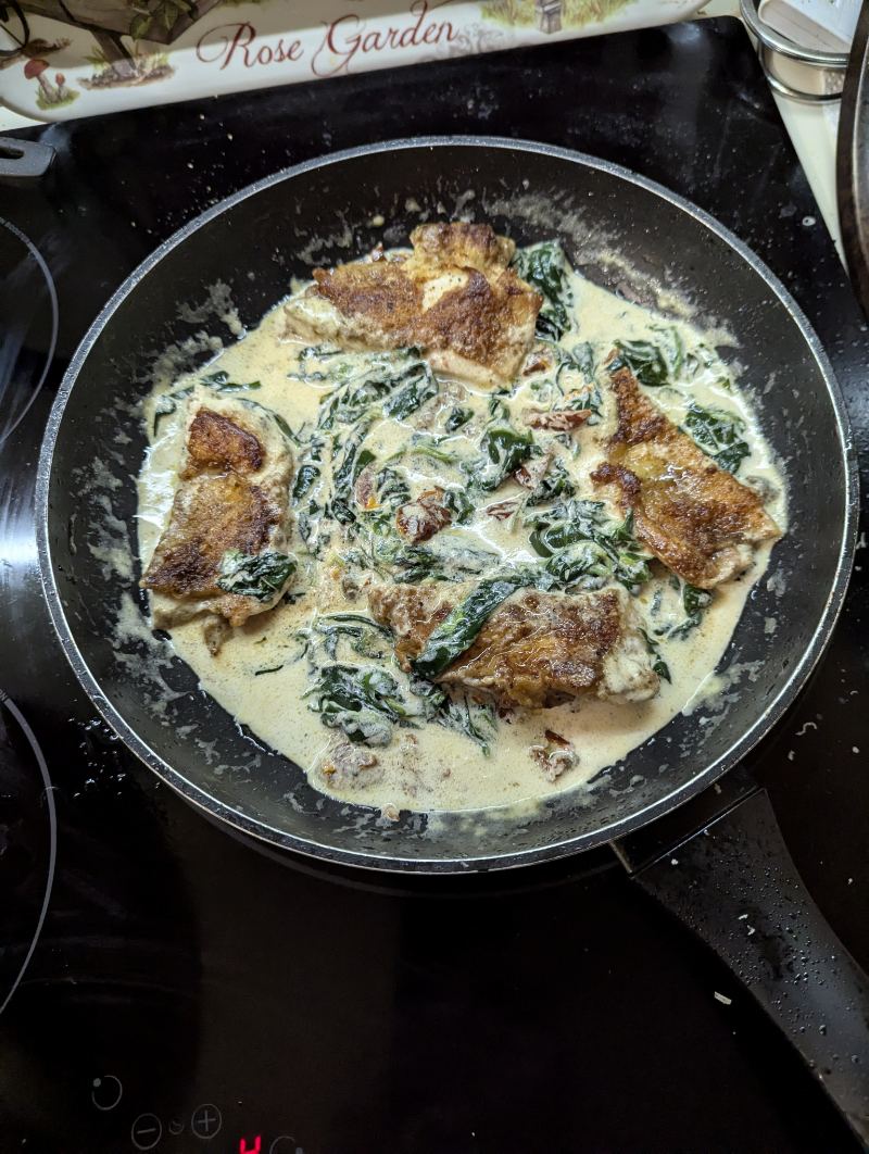 Chicken thighs in creamy sauce of spinach and parmesan